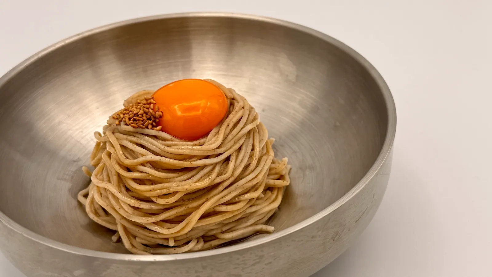 濃厚な卵黄と特製だれを絡めたソバックスのTKM(たまごかけ麺)を器に盛った様子